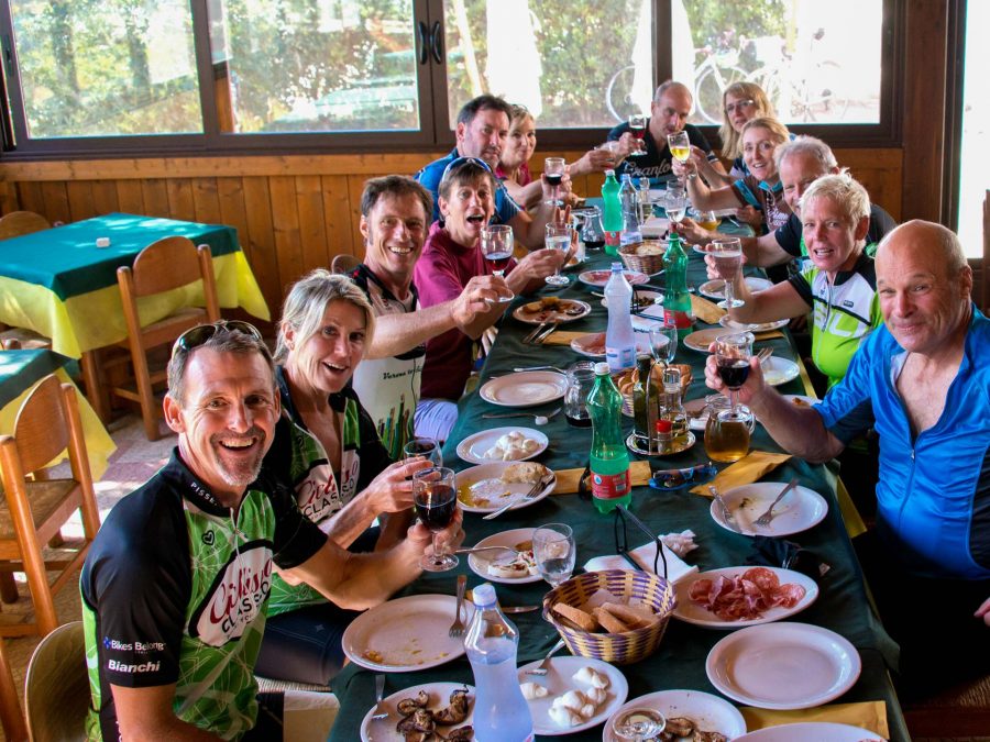 Bike group toasting and eating dinner