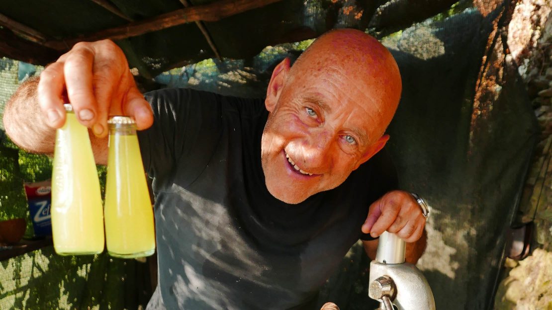 man in cinque terre holding drinks