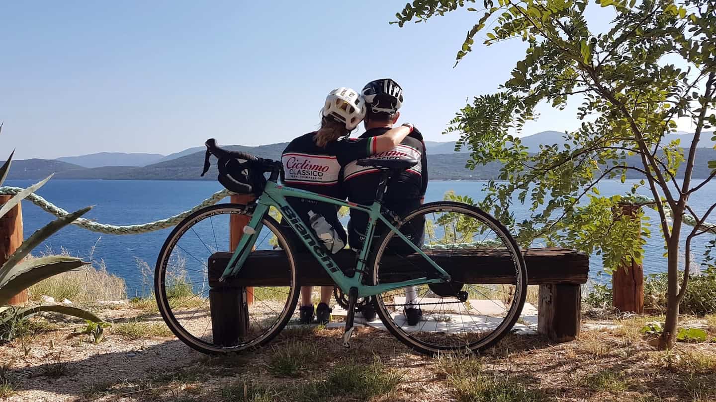 Biking along scenic lakeside in Italy during guided bike tour with Ciclismo Classico.