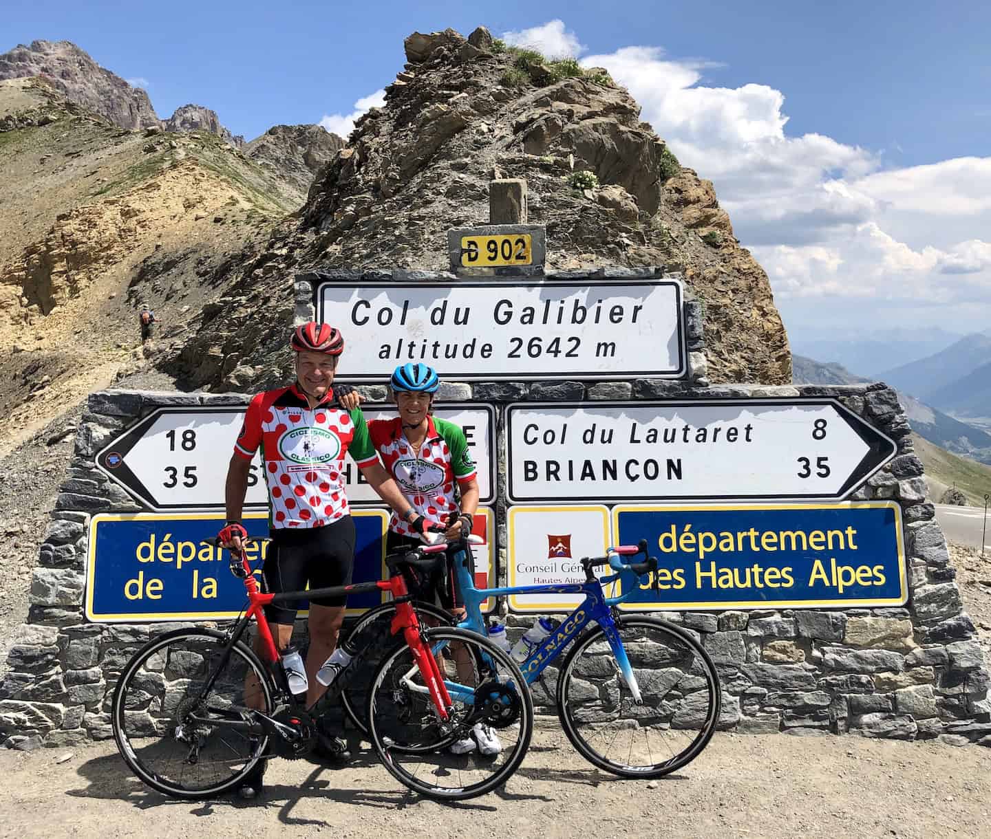 Bikers at Col du Galibier mountain pass in the French Alps during an Italy bike tour, enjoying scenic views and challenging climbs on competitive cycling routes.
