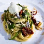 Authentic Italian pasta dish with fresh vegetables, sun-dried tomatoes, and creamy sauce, perfect for Italy bike tours offered by Ciclismo Classico.