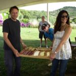 Vibrant outdoor Italian countryside with cyclists enjoying a meal after bike tour, lush greenery and scenic hills in Italy, ideal for Italy bike tours, best biking experiences.