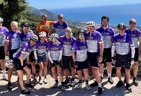 Group of cyclists enjoying a scenic ride along the Italian coast with stunning ocean views and lush landscapes, highlighting Italy's best biking routes and cycling experiences.