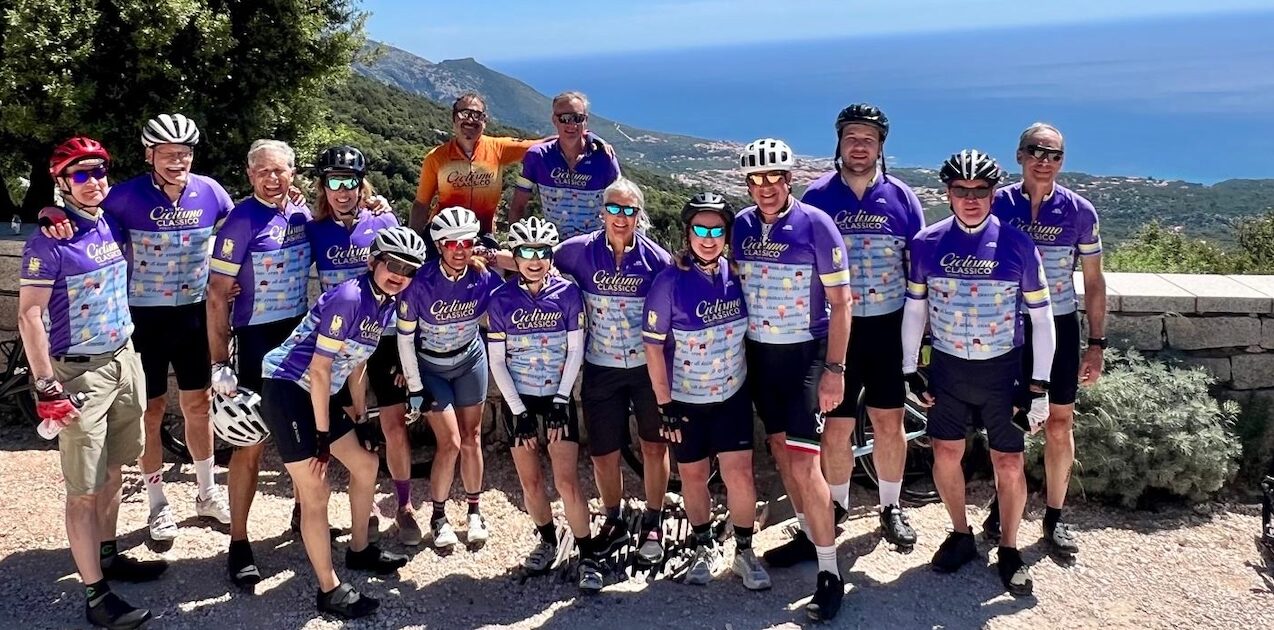 Group of cyclists enjoying a scenic ride along the Italian coast with stunning ocean views and lush landscapes, highlighting Italy's best biking routes and cycling experiences.