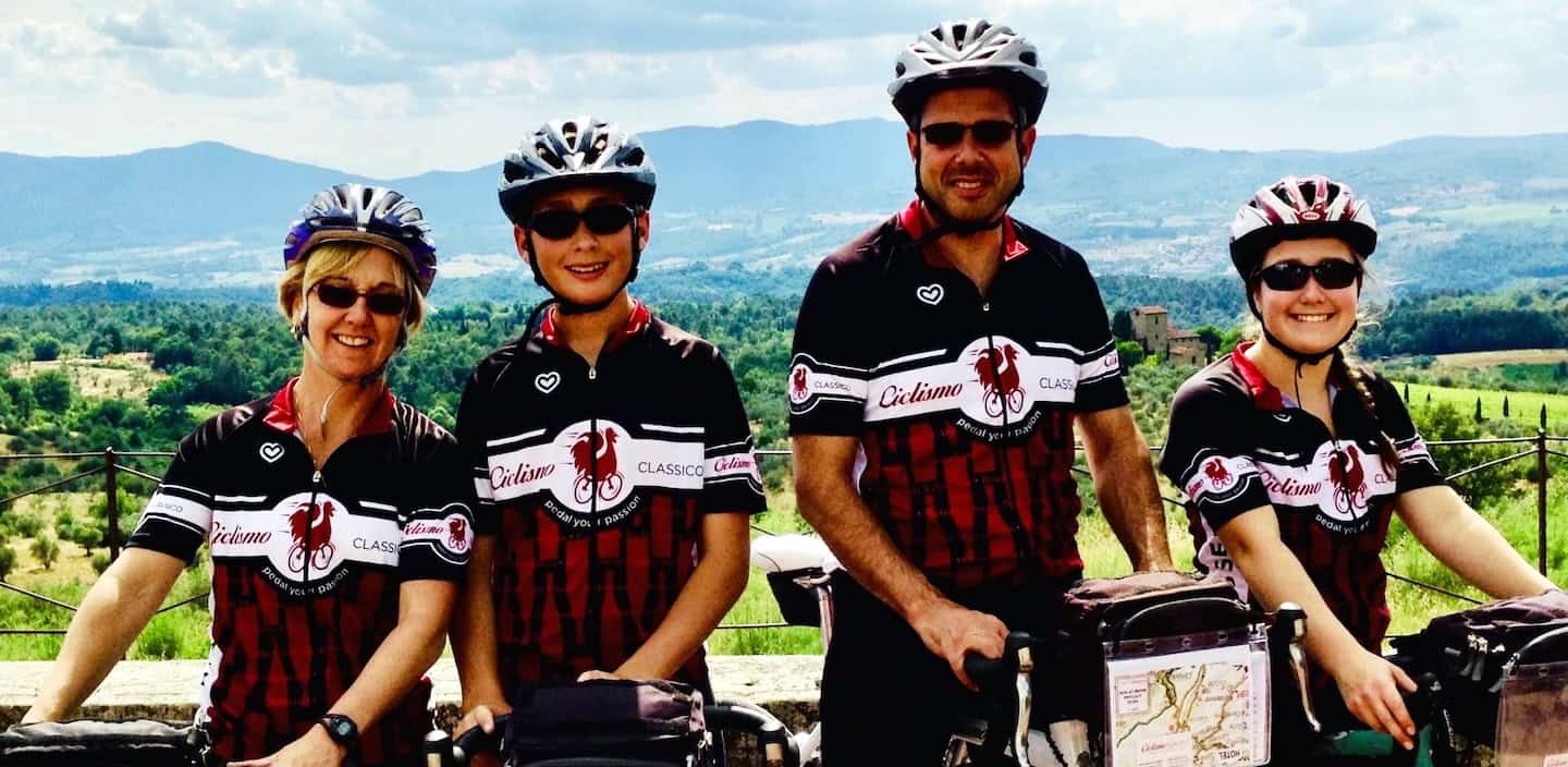 Group of cyclists enjoying Italy bike tours with Ciclismo Classico, showcasing scenic landscapes and professional bike tour experiences in Italy.