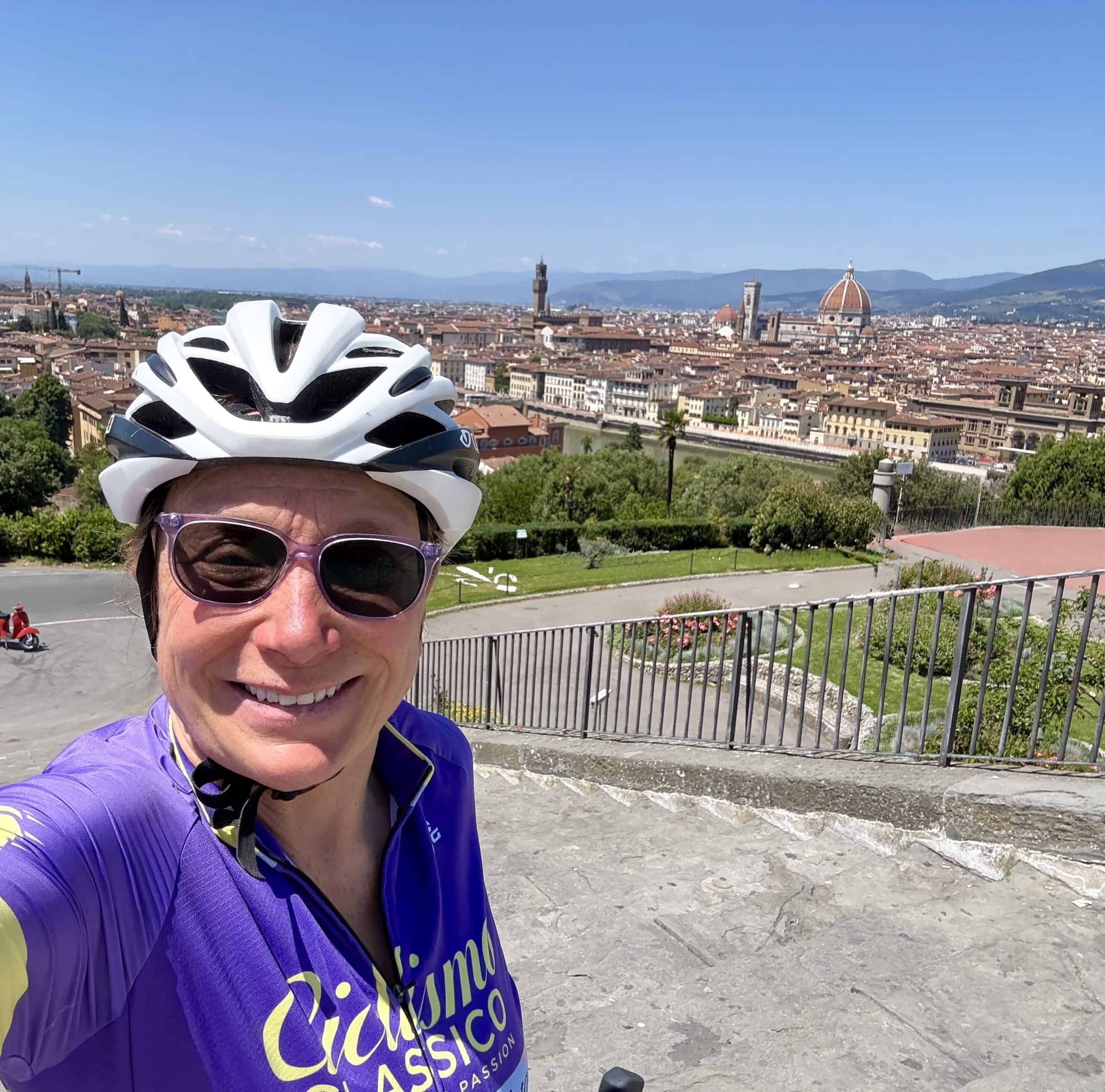 Cyclist enjoying a scenic bike tour in Italy with views of Florence and the Duomo, highlighting top Italy bike tour companies and cycling experiences.